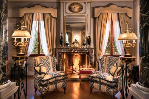 a living room with two chairs and a fireplace at Villa Margherita in Mira