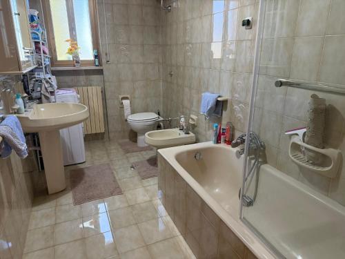 a bathroom with a tub and a toilet and a sink at Villa OLGA in Ginosa Marina