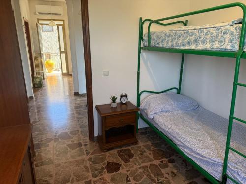 a bedroom with two bunk beds and a table at Villa OLGA in Ginosa Marina