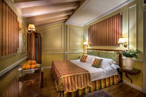 a bedroom with a bed and a table with fruit on it at Villa Margherita in Mira