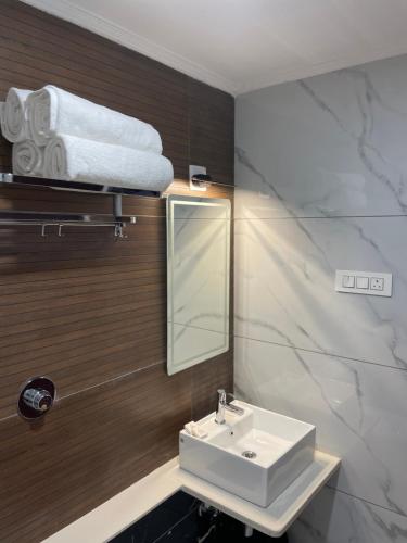 a bathroom with a sink and a mirror at Hotel Durga International in Udupi