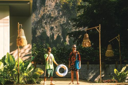 two men are standing in front of a building at Marina Express-Fisherman Aonang in Ao Nang Beach