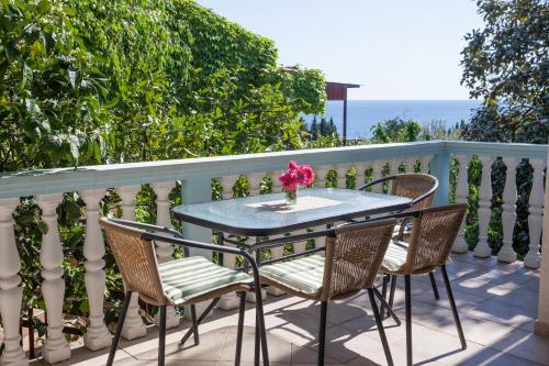 a table and chairs on a balcony with the ocean at Panorama Apartments in Budva
