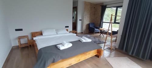 a bedroom with two beds with white towels on them at Merze Suit Otel in Çamlıhemşin