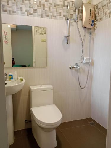 a bathroom with a toilet and a sink and a shower at Villa Cresenciana in Batuan
