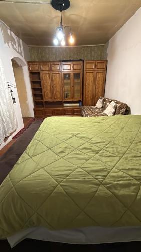 a bedroom with a large green bed in it at Green side in Ganja