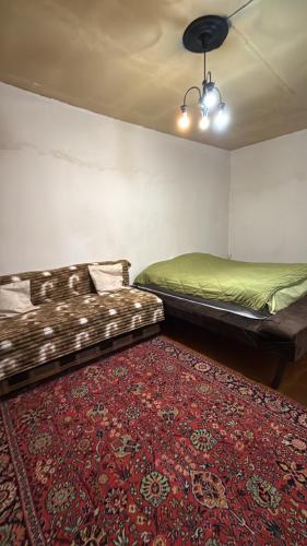 two beds sitting in a room with a rug at Green side in Ganja