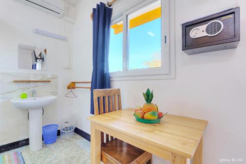 a bathroom with a table with a bowl of fruit on it at VaoVao Hotel in Nosy Be