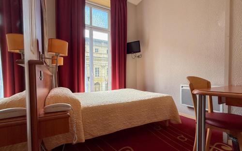 a hospital room with a bed and a window at Hotel de L'Opéra in Bordeaux