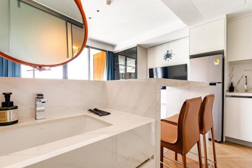 a bathroom with a tub and a mirror at Sunshine by Villacarte in Layan Beach