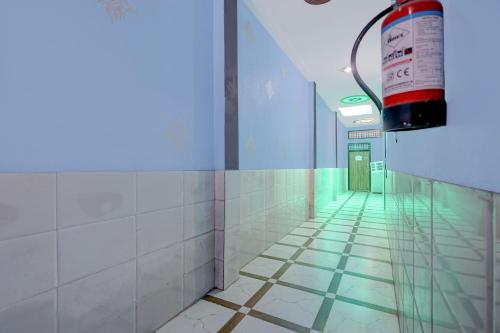 ailed hallway with a fire extinguisher in a building at Spot On Moonlight Hotel in Jhajjar