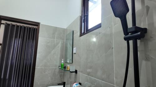 a bathroom with a shower with a mirror and a shower at wild elephant reach wilpaththuwa in Nochchiyagama