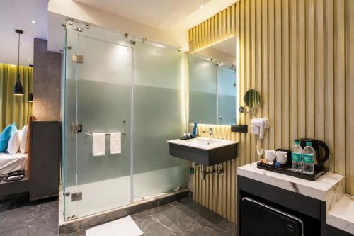 a bathroom with a glass shower and a sink at SKI Hotels and Resorts in Rishīkesh