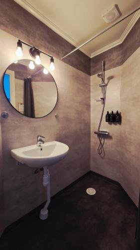 a bathroom with a sink and a mirror at Leopold Boutique Hotel in Östersund