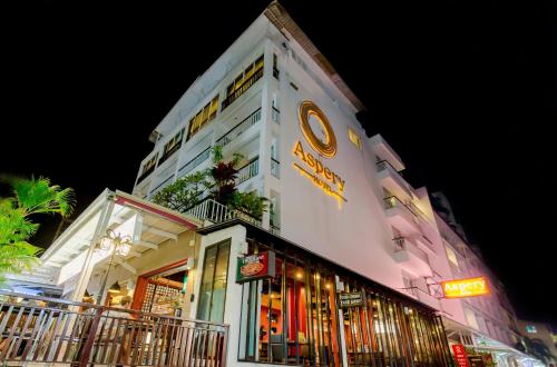 a building with a sign on the side of it at Aspery Hotel in Patong Beach