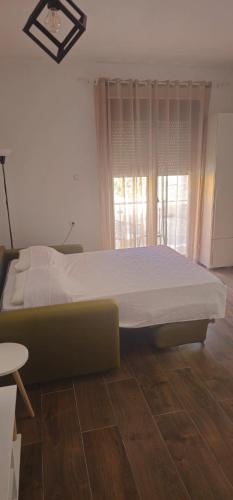 a large bed in a room with a window at Apartments Agnes in Dobrota