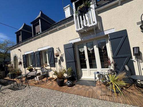 a building with chairs and tables on a patio at Maison, atypique, proche, mer in Plérin