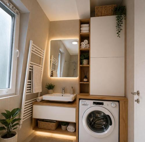 a small bathroom with a washing machine and a sink at Oaza in Bjelašnica
