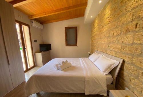 a bedroom with a bed with two towels on it at Le tenute di punta bianca in Agrigento
