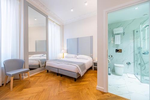a bedroom with two beds and a glass shower at Hosianum Palace in Rome