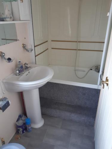 a bathroom with a sink and a shower and a toilet at Sea View Static Caravan With Decking - Skipsea Sands Holiday Park in Skipsea