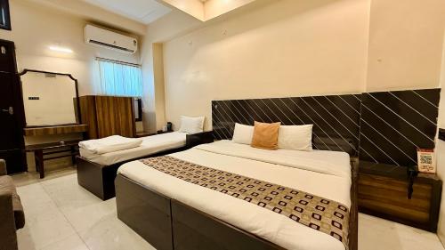 a hotel room with a bed and a projection screen at Hotel New Sunder in Indore