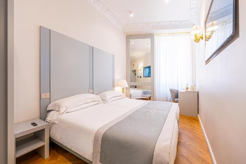 a bedroom with a large white bed in a room at Hosianum Palace in Rome