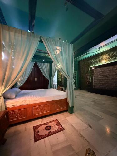 a bedroom with a bed with a canopy at H&R Homestay in Guwahati