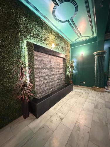 a room with a brick wall with plants on it at H&R Homestay in Guwahati