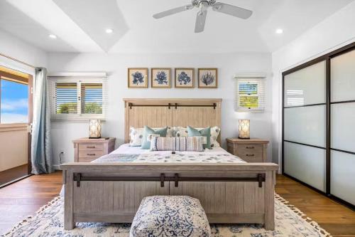 a bedroom with a large bed and a ceiling fan at Pacific Combo WOcean View Private Patio in Ventura