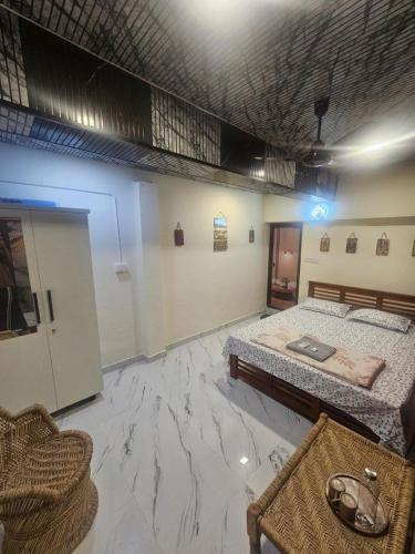 a bedroom with two beds and a marble floor at Richard's Homestay -Classy AC Rooms in Thiruvalla