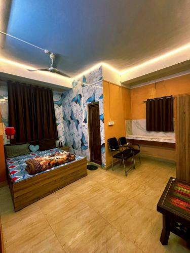a room with a bed and a rock wall at The Pinnacle Stays in Guwahati