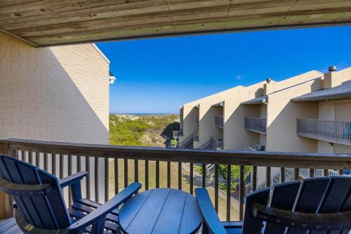 a balcony with chairs and a view of a building at QCB5 - Saltaire Sunrise in Nags Head