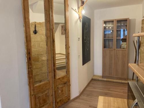 a room with a wooden door and a hallway at Mamma Adelina in Enna