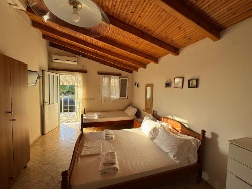 a bedroom with a bed and a living room at Rexhos Studios in Himare