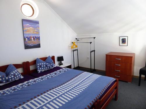 a bedroom with a bed with a blue comforter at Apartment Cindy in Herceg-Novi