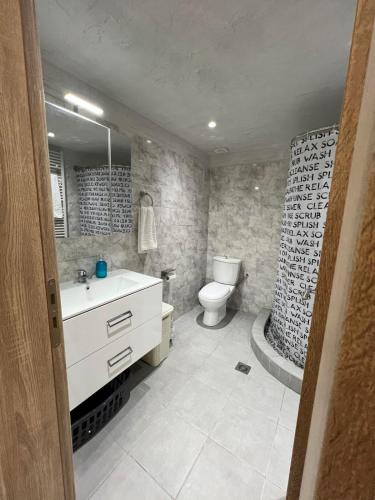 a bathroom with a sink and a toilet and a tub at Athanasia's Eremion in Zagora