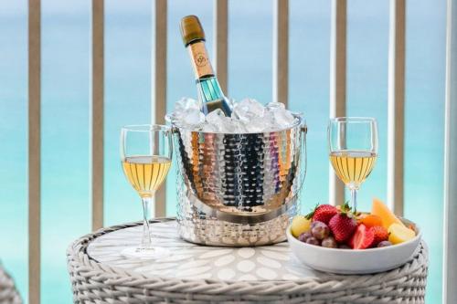 a bucket of ice and a bottle of champagne and fruit at Splash Resort Luxury Pools Lazy River Water Parks Sept still Available in Panama City Beach