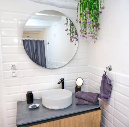 a bathroom with a sink and a mirror at Plomari Nest in Plomari
