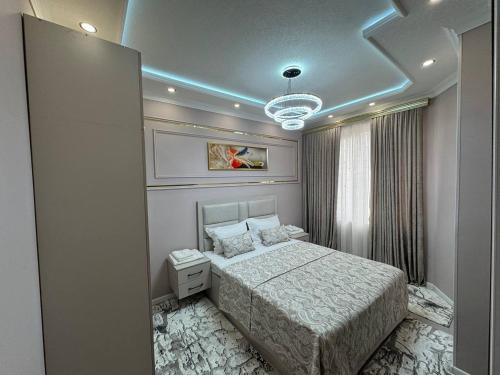 a bedroom with a bed in a room at Runa modern flat in Samarkand