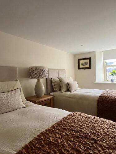 a bedroom with two beds and a couch at Kittys Haven in Castlemaine