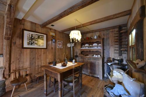 a dining room with wooden walls and a wooden table at Hotel La Rouja in Champoluc