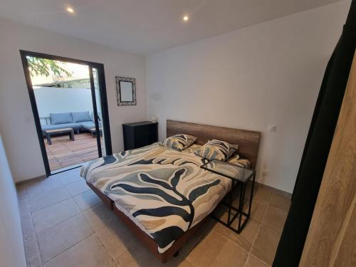 a bedroom with a bed with a zebra print sheets at Escapade à Saint-Saturnin-les-Avignon in Jonquerettes