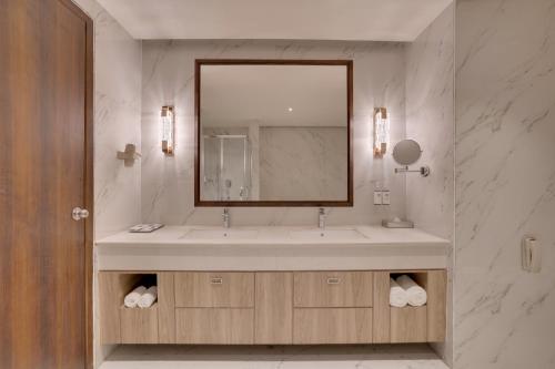 a bathroom with a sink with a large mirror at Keys Select By Lemon Tree Hotels, Chirang in Bongaigaon