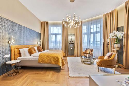 a bedroom with a bed and a chandelier at Mestský Hotel Ďumbier in Brezno