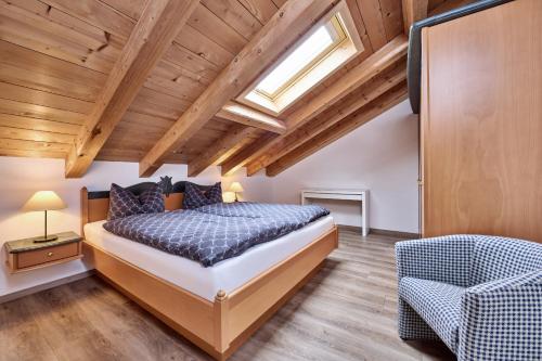 a bedroom with a bed and a skylight at Ferienhaus Magdalena in Mittenwald