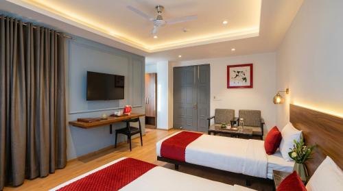 a hotel room with a bed and a desk at Yashobhoomi Hotel Grand Tashree in New Delhi