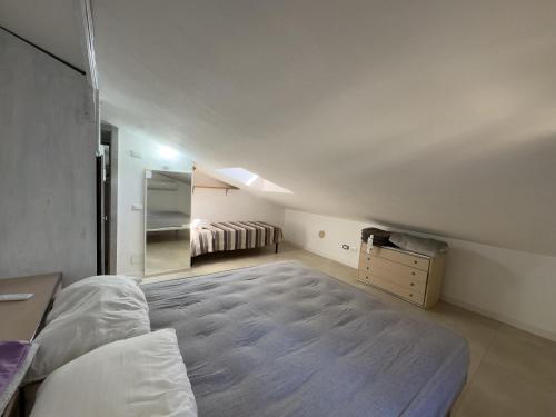 a bedroom with a large bed and a mirror at La casina di Sara in Cavo