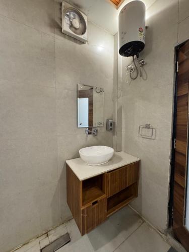 a bathroom with a sink and a mirror at CNS Hotels in Ghaziabad