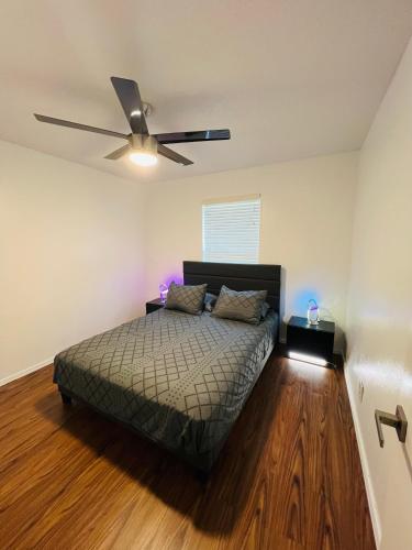 a bedroom with a bed and a ceiling fan at Lion House in Bentonville